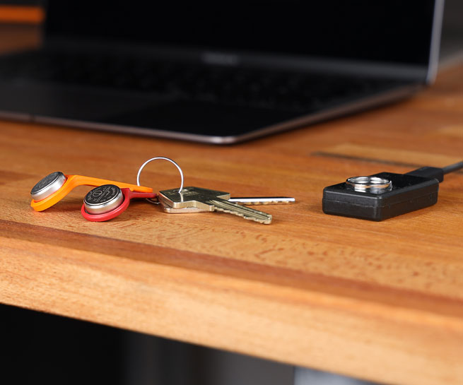 iButtons with keyring mount lying on a table